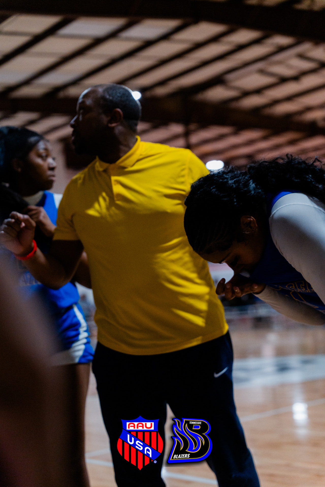 Coach instructing a TN Blazers player courtside